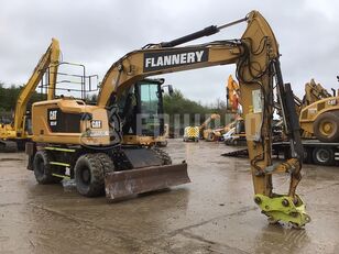 Caterpillar M314F with blade, stabilizers and GP bucket Mobilbagger
